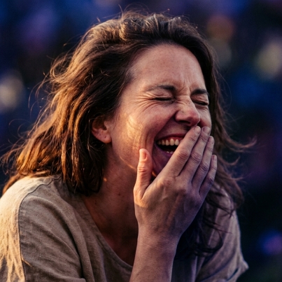 Woman_laughing_in_golden_light_202608061042