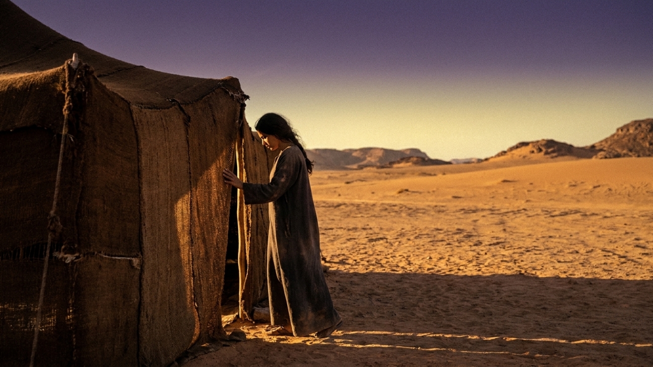 Woman_standing_at_desert_tent_202608031316