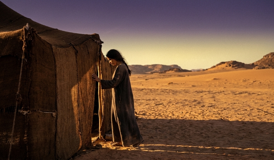 Woman_standing_at_desert_tent_202608031316